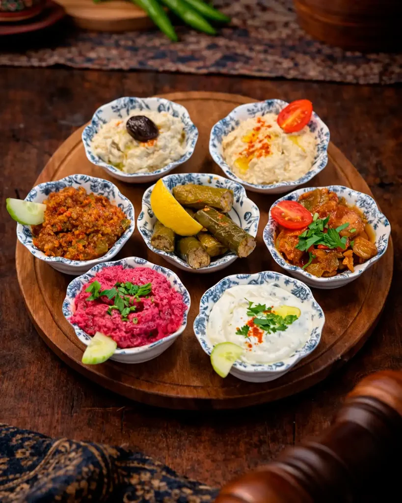 A selection of traditional Mediterranean starters served cold creamy dips, fresh vegetables, and savory spreads bursting with authentic Middle Eastern flavors.