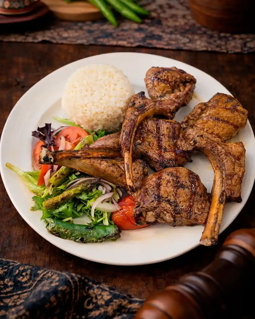 Lamb Chops (Kuzu Pirzola) Grilled lamb chops served with rice and salad.
